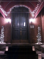The Olde North Chapel entrance and night illuminated with white lights and luminaries