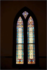 One of the historical stained glass window designs at The Olde North Chapel, an historical wedding chapel in Richmond, Indiana