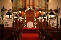 These decorated pew lanterns line the aisle and are Exclusive to The Olde North Chapel.  Historic Indiana wedding chapel.  Richmond, Indiana wedding ceremony site.