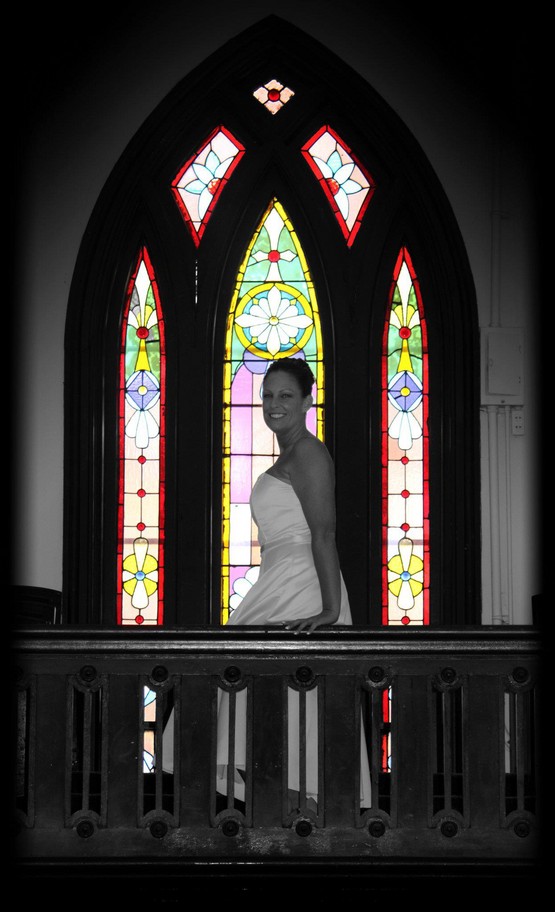 Kathy in front of the beautiful historical stained glass window at the historical wedding chapel, Richmond, Indiana.  The Olde North Chapel, wedding venue, Richmond, Indiana.